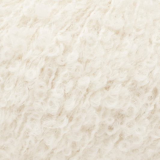 Detailaufnahme von der Wolle DROPS Alpaca Bouclé in der Farbe 0100 natur. 