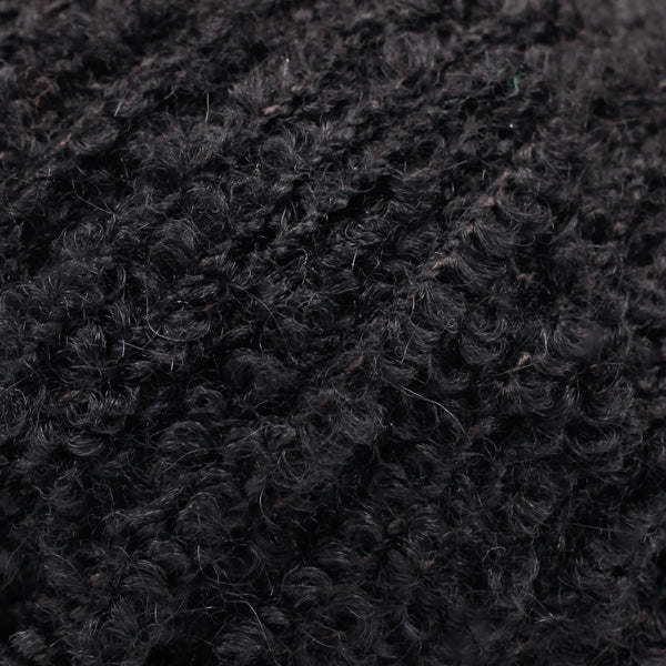 Detailaufnahme von der Wolle DROPS Alpaca Bouclé in der Farbe 8903 schwarz. 