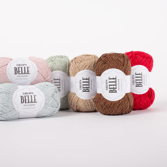 Sechs DROPS Belle Knäuel in verschiedenen Farben.